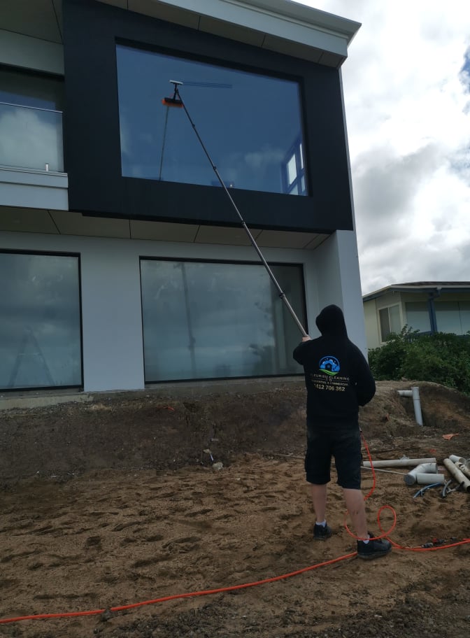 Man cleaning Multi-storey building windows